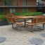 Table & Bench Quadro outdoor furniture in a garden courtyard.