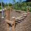 Outdoor playground equipment Sintra made of wooden posts with crossbars for climbing, on a bark chip