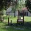 Outdoor wooden playground equipment Sintra in a green backyard.