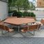 Outdoor wooden octagonal Table & Bench with 6 seats in a patio area
