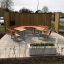 Outdoor School Table & Bench set in a paved area with wooden partition panels.