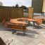 Wooden School Table & Bench set in a hexagonal arrangement on a paved outdoor area.