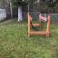 Wooden playground climbing structure for children in a park.