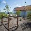 Wooden playground structure Kongo in a landscaped area.
