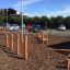 Kongo outdoor playground equipment on bark surface with climbing elements and logs