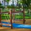 Playground equipment 'Kongo' with wooden frames and hanging ropes in a park setting.