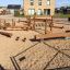 Kongo playground set made of wooden elements on a sand surface.