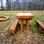 Outdoor wooden Table & Bench Nature set in a backyard garden.