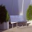 Rosaly bench between two large potted plants outdoors