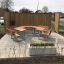 Outdoor picnic table set Milano with integrated benches on tiled patio.