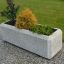 Rectangular Milano concrete planter with various plants.