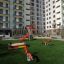 Shock Absorbing Pad 25mm with artificial grass installed in a modern playground.