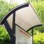 Kemi park information board with a modern curved roof in a green park setting