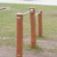 Outdoor fitness equipment Double Somersault Nature featuring wooden posts and metal bars.