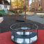 Playground equipment Barrel with red flooring and metal frame.