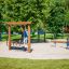 Children playing on Barrel playground equipment at a park.