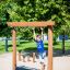 Child playing on Barrel playground equipment at a park.