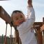 Child playing on Lianes wooden playhouse.