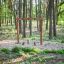 Lianes wooden playhouse in a forest playground setting.