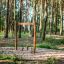 Lianes wooden playhouse in a forest playground setting.