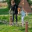 Children playing on Diamond net climbing structure in a park.