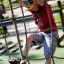Child climbing on Butterfly climbing net in a playground.