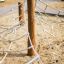Gossamer climbing net for children on a sandy playground.