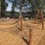 Children's playground with Gossamer climbing net and wooden structures.
