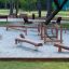 Sahara wooden seesaw playground equipment in a sandy play area