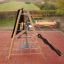 Tipi II climbing net on a playground with red tiles