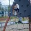 Child climbing on Tipi II climbing net structure outdoor playground