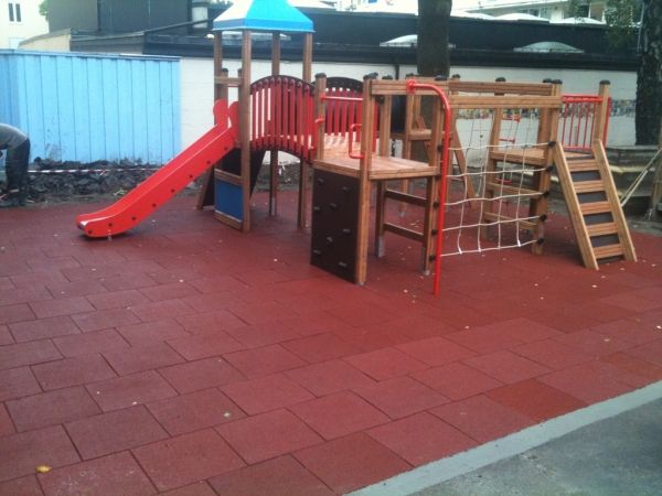 Playground with wooden equipment and Rubber Tiles 110 flooring.