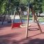 Rubber Tiles 110 used in playground with wooden swing set.