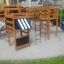 Large wooden playground set with slides and climbing nets on Wetpour 40 surface.