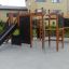 Wetpour 60 playground equipment with slide and climbing structure in a residential area.