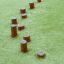 Wooden stepping posts for playground Cape Code on green grass.