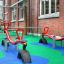 Playground with red seesaws on Wetpour 120 safety surface.