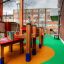 Playground area with Wetpour 120 surface and wooden play structures.
