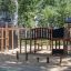 Wooden playground structure Madagascar (5 pcs set) in a park.