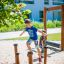 Children playing on Madagascar (5 pcs set) playground equipment.