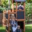 Children playing on the Country House Nature wooden playground set