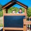 Children playing in Knight's Castle Nature playhouse with slide.