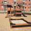 Knight's Castle Nature playhouse with slide and sandbox in playground area