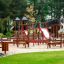 Mastodont castle with slide wooden playground structure in park