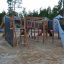 Mastodon castle with slide playground equipment in a park setting