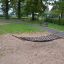 Hammock in a playground with wooden posts.