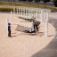 Children playing on a Hammock at a playground.