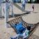 Children playing on a Hammock at a playground.