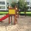Toddler Tower Slide with red slide and yellow panel in a playground.
