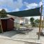 Sun Shade Square Pioneer (Larchwood) providing shade over picnic tables in an outdoor area.